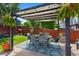 Outdoor patio with a shade structure over the dining set is great for entertaining guests at 18496 Keyser Creek Ave, Parker, CO 80134