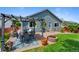 Backyard with patio, dining set, firepit, and well maintained lawn at 18496 Keyser Creek Ave, Parker, CO 80134