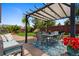 Relaxing backyard patio featuring a dining set, outdoor lounge seating, and shade under a pergola at 18496 Keyser Creek Ave, Parker, CO 80134