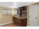 Basement wet bar area featuring granite countertops, wine storage, and custom cabinets at 18496 Keyser Creek Ave, Parker, CO 80134