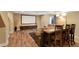 Spacious finished basement featuring wood floors, a media area, and a dining area at 18496 Keyser Creek Ave, Parker, CO 80134