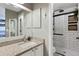 Bright bathroom with granite countertop vanity, and a modern walk-in shower at 18496 Keyser Creek Ave, Parker, CO 80134