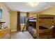 Bedroom featuring a bunk bed, carpet, window, and dresser at 18496 Keyser Creek Ave, Parker, CO 80134