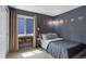Cozy bedroom with a twin bed, window, and cute solar system wall art at 18496 Keyser Creek Ave, Parker, CO 80134