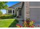 Close-up view of home exterior, showing the front door, bay window, flower pots, and landscaping at 18496 Keyser Creek Ave, Parker, CO 80134