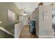 Inviting hallway features wood floors, a decorative painting, and a sign that reads 