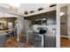 Updated kitchen features stainless steel appliances, granite countertops, and stylish dark cabinetry at 18496 Keyser Creek Ave, Parker, CO 80134