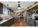 Well-lit kitchen showcases hardwood floors, granite countertops, stainless steel appliances, and open access to the dining area at 18496 Keyser Creek Ave, Parker, CO 80134
