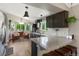 Bright, open kitchen features granite countertops, a breakfast bar, and a cozy sitting area with bay windows at 18496 Keyser Creek Ave, Parker, CO 80134
