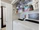 Laundry room with washer, dryer, shelving, and organized storage bins at 18496 Keyser Creek Ave, Parker, CO 80134