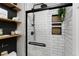 Modern walk-in shower features black fixtures, white subway tile, and built-in shelving at 18496 Keyser Creek Ave, Parker, CO 80134