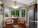 Cozy breakfast nook area with bay windows, comfortable chairs, and stylish decor at 18496 Keyser Creek Ave, Parker, CO 80134
