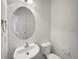 Well-lit half bathroom with a round mirror and modern fixtures at 12713 Leyden St # E, Thornton, CO 80602