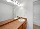Clean bathroom featuring a long vanity and a bright light fixture at 12713 Leyden St # E, Thornton, CO 80602