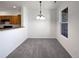 Dining area with chandelier lighting, a large window, and an open view to the kitchen at 12713 Leyden St # E, Thornton, CO 80602