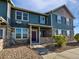 Attractive townhouse with stone accents, blue siding, and a covered front porch at 12713 Leyden St # E, Thornton, CO 80602