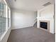 Bright living room showcasing a fireplace, staircase, and large windows for natural light at 12713 Leyden St # E, Thornton, CO 80602