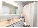 Bright bathroom featuring a white vanity, mirror, and shower with curtain rod at 1537 S Owens St # 31, Denver, CO 80232