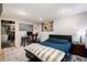 Spacious bedroom features a bed, rug, and desk illuminated by recessed lighting at 1537 S Owens St # 31, Denver, CO 80232