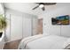 Bedroom featuring a comfortable bed, a closet with white doors, and a modern ceiling fan at 1537 S Owens St # 31, Denver, CO 80232