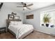 Cozy bedroom with neutral tones, featuring a queen bed, a ceiling fan, and a bright window at 1537 S Owens St # 31, Denver, CO 80232