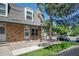 Inviting townhome showcasing a brick facade, landscaped front yard, and a cozy entrance at 1537 S Owens St # 31, Denver, CO 80232