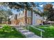 Attractive townhome featuring brick and siding, complemented by a well-maintained lawn at 1537 S Owens St # 31, Denver, CO 80232