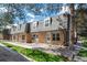 Charming multi-Gathering townhome complex with brick facade and well-kept landscaping on a sunny day at 1537 S Owens St # 31, Denver, CO 80232