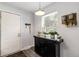 Entryway featuring a sleek black console table with house plants, a door and a window at 1537 S Owens St # 31, Denver, CO 80232