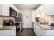 Bright kitchen featuring white cabinets, stainless steel appliances, and granite countertops at 1537 S Owens St # 31, Denver, CO 80232