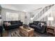 Bright living room with cozy couches, wood-look floors, and staircase access at 1537 S Owens St # 31, Denver, CO 80232