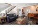 Comfortable living room with staircase access, gray sofas, and wood-look floors at 1537 S Owens St # 31, Denver, CO 80232