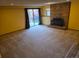 Bright basement space with brick fireplace, sliding glass doors, and plush neutral carpeting at 262 Yank Ct, Lakewood, CO 80228