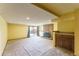 Spacious basement featuring a brick fireplace, carpeted floors, sliding glass door and wet bar at 262 Yank Ct, Lakewood, CO 80228