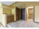 View of basement with carpeted floors, cabinets, dark bi-fold doors and stairs leading up at 262 Yank Ct, Lakewood, CO 80228