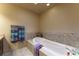Soaking tub with tile surround and decoratively displayed towels at 262 Yank Ct, Lakewood, CO 80228