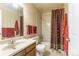 Bright bathroom features a shower-tub combo and oak-trimmed vanity at 262 Yank Ct, Lakewood, CO 80228