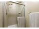 Bathroom shower with sliding glass door and tiled surround at 262 Yank Ct, Lakewood, CO 80228