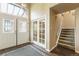 Elegant foyer featuring a staircase, glass french doors, and wood floors with a rug at 262 Yank Ct, Lakewood, CO 80228
