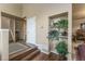 Bright and spacious foyer with decorative shelving, hardwood floors, and entry to the staircase at 262 Yank Ct, Lakewood, CO 80228