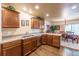 Functional kitchen with wood cabinets, countertops, and view into the dining area at 262 Yank Ct, Lakewood, CO 80228