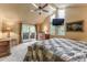 Main bedroom boasts vaulted ceilings, TV, large windows, and patio access at 262 Yank Ct, Lakewood, CO 80228