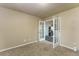 Cozy office featuring neutral walls, carpet, a large window and glass french doors at 262 Yank Ct, Lakewood, CO 80228