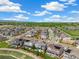 Stunning aerial view of a residential neighborhood showcasing the community and mountain views at 800 Meadowlark Dr, Erie, CO 80516