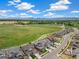 Panoramic aerial view showcasing the neighborhood, open green spaces, and stunning mountain views in the distance at 800 Meadowlark Dr, Erie, CO 80516