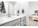 Modern bathroom featuring double sinks, sleek gray cabinetry, and large mirror at 800 Meadowlark Dr, Erie, CO 80516