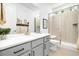 Modern bathroom features dual sinks, a sleek vanity, and a glass-enclosed shower, creating a spa-like experience at 800 Meadowlark Dr, Erie, CO 80516