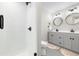 Contemporary bathroom featuring double sinks, sleek cabinets, and walk-in shower at 800 Meadowlark Dr, Erie, CO 80516