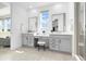Bathroom with double vanity sinks, makeup vanity and glass shower at 800 Meadowlark Dr, Erie, CO 80516