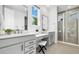 Bathroom featuring double vanity sinks, makeup vanity and glass shower at 800 Meadowlark Dr, Erie, CO 80516
